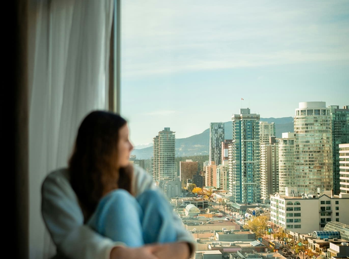 Women staring out of the window into a foreign city.