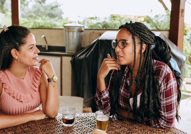 Friendship when living between cultures is not easy, two female friends having a drink