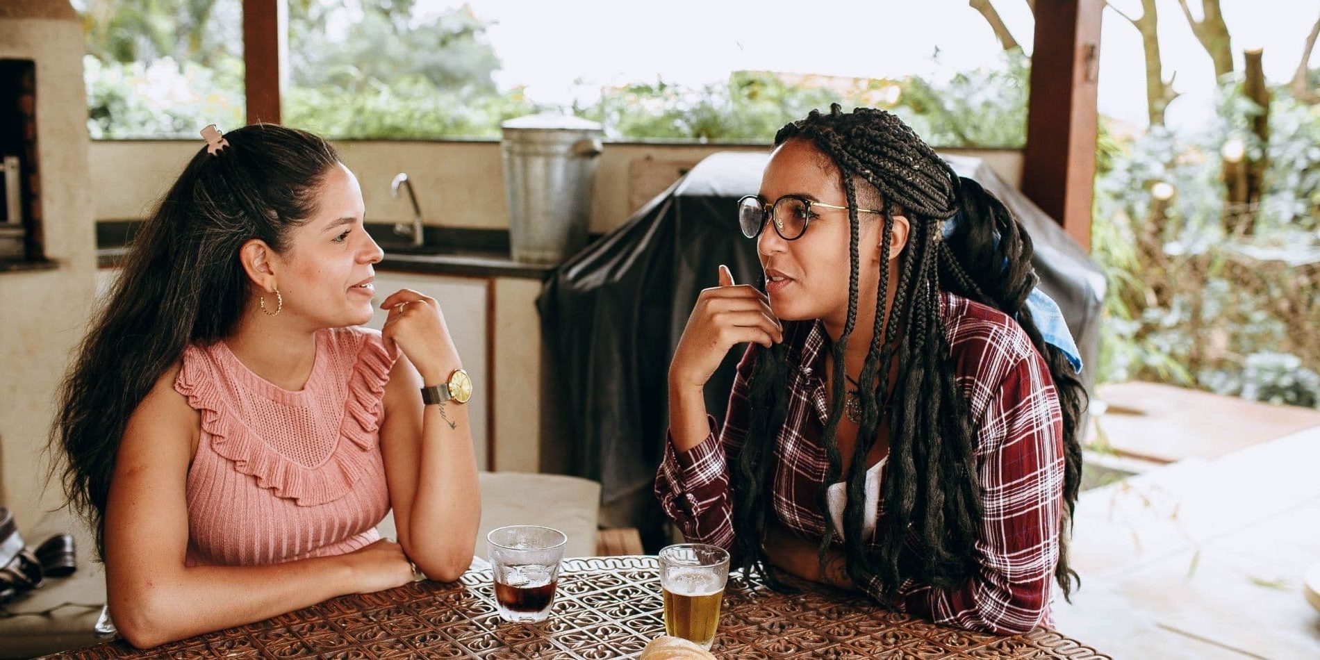 Friendship when living between cultures is not easy, two female friends having a drink